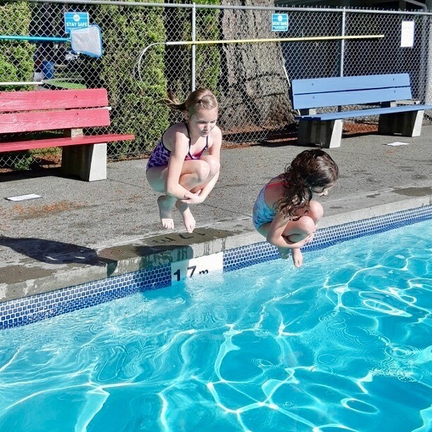 two kids jump in pool